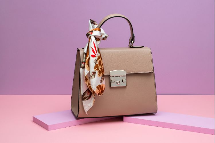 Female leather bag with a colorful silk scarf