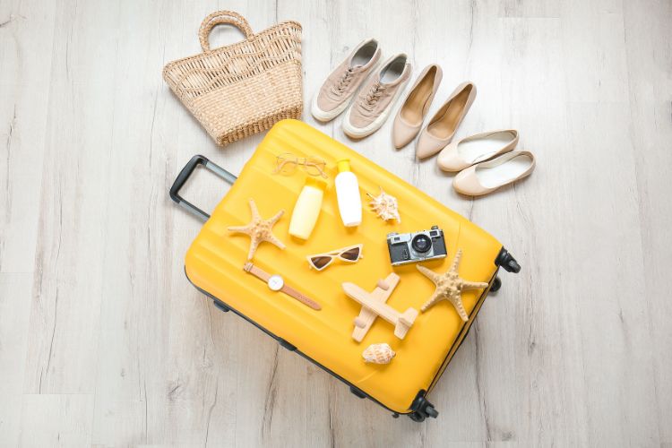 Suitcase and Travel Accessories and shoes on the floor